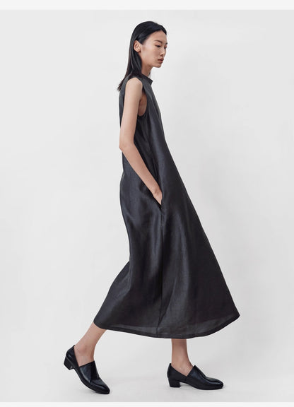 model standing facing on the side against grey wall wearing sleeveless Xiangyunsha silk dress